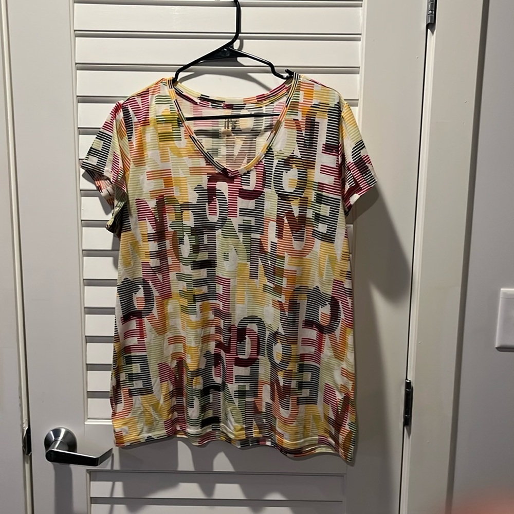 Multi colored t-shirt. The letters spell Queen.